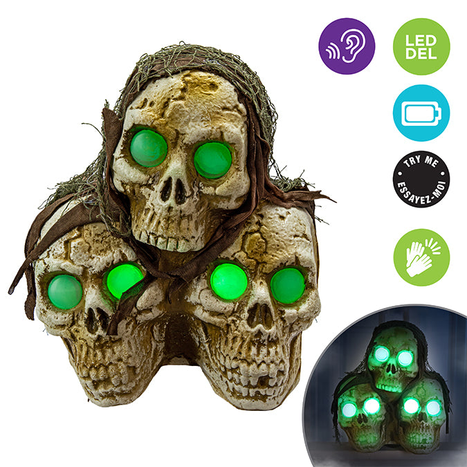 Stacked plastic skulls with lights and sounds, green LED