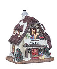 Small illuminated Christmas village house